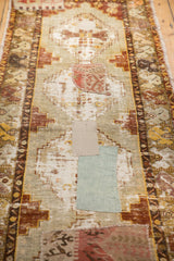 Fragmented kilim patchwork and distressed texture on pale blue vintage Oushak runner.