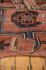 Distressed vintage Turkish Kars rug; blush and navy geometric pattern, kilim patch.