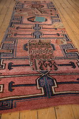 Close-up of distressed vintage Kars rug showing geometric kilim patchwork in dusty blush, navy.