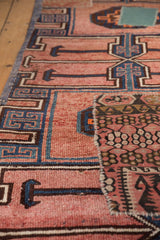 Distressed dusty blush Kars rug pile with bold navy geometric pattern and colorful kilim patchwork.