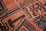 Distressed geometric patchwork on a vintage Kars runner, in dusty blush and navy blue.