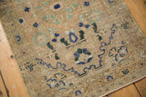 Textured field of blossomed plants in navy, mint on this distressed Hamadan rug.