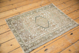 Distressed Karaja rug corner, geometric patterns with low pile in soft beige and oxidized silver.