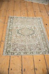 Distressed texture and geometric patterns on a vintage Karaja rug mat's secured side.