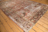 Geometric floral patterns and distressed texture on the Heriz border in pale raspberry and sage.
