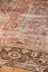 Distressed texture of a vintage Heriz carpet, revealing geometric florals and soft tones.
