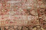 Distressed vintage Heriz carpet texture with geometric motifs, pale raspberry, oxidized silver, sage.