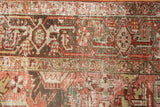 Distressed Heriz carpet detail: geometric floral design with worn pile in pale red and silver.