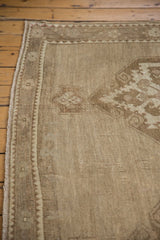 Vintage Distressed Oushak rug's secured side and field, showing low pile, beige, and sand.