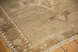 Softened tones and even low pile wear on a vintage distressed Oushak carpet.