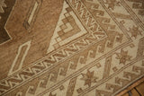 Distressed vintage Oushak carpet with reciprocating wave border and geometric patterns.