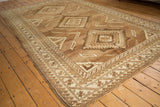 Distressed vintage Oushak rug with geometric medallions and soft abrashes in sand and beige.