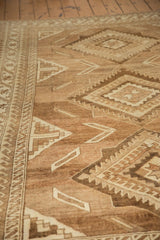Textural detail of distressed Oushak rug, geometric motifs and reciprocating wave border.
