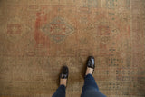 Distressed Oushak rug surface showing low pile, pale rose, ivory, and ocean green abrashes.