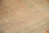 Distressed low pile vintage Oushak rug with faded blush, ivory, and ocean green tones.