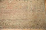 Distressed Oushak corner with faded beige, blush tones, low pile, and fringe.