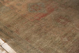 Distressed vintage Oushak carpet, showcasing low pile, faded rose, and muted green tone-on-tone abrashes.