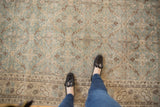 Muted ocean green, beige, and brown allover lattice on distressed vintage Sparta rug.