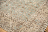 Distressed vintage Sparta carpet corner, with ocean green lattice pattern and beige border motifs.