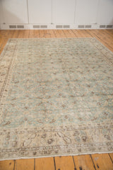 Distressed Turkish Sparta carpet showing worn ocean green and beige lattice leaves, foundation visible.