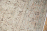 Faded ivory, apricot, pale blue floral vinery on distressed Sparta carpet's worn pile.