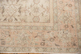 Corner of distressed Sparta carpet, faded apricot floral patterns, showing even wear to foundation.