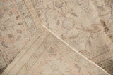 Hand knotted foundation and distressed floral design with ivory, apricot, and silver tones.
