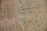 Distressed Sultanabad rug's low pile, revealing mallard green and terra cotta Herati motifs.