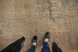 Distressed Sultanabad carpet's worn low pile, Herati field in ivory, mallard green, terra cotta.