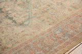 Distressed antique Sultanabad rug border with soft blue, red, and meandering leaf design.