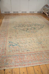 Powder blue border with terra cotta floral and samovar motifs on distressed Sultanabad rug.
