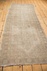 Distressed vintage Oushak runner pile with even wear, featuring pale blush, ivory, and sand tones.