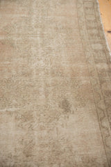 Distressed Oushak rug runner showcasing faded beige tones, even wear to knot heads, and discoloration.