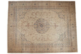 Distressed Sparta carpet with a central medallion and floral vinery in faded navy and dusty red over an ivory ground.