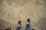 Worn pile of a vintage Sparta carpet showing navy blue scrolling arabesques and dusty red florals.