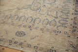 Close-up showing the even wear and low pile of a distressed Sparta carpet with navy blue floral borders.