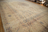 Angled view of a distressed Sparta carpet's worn pile, showing floral borders in navy and dusty red.
