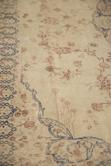 Distressed texture of a vintage Sparta rug with navy blue and dusty red floral details.