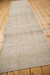 Distressed Sparta runner's faded scrolling vinery and blossom motifs, showing even wear.