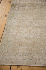 Distressed vintage Sparta runner texture, showing even wear, faded vinery, and narrow border.