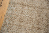 Faded scrolling vinery motif and even wear on the distressed vintage Sparta runner pile.