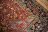 Heriz carpet's cherry red field, geometric florals, and navy blue classic turtle border.