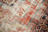 Vintage Heriz carpet texture, showing faded brick red and ivory pattern with visible foundation.