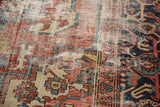 Vintage Heriz carpet detail with exposed knot heads, foundation, and brick red, navy blue pattern.