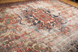 Vintage Heriz carpet corner: distressed texture, foundation showing, navy meandering vine border.