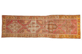 Distressed vintage Oushak rug runner, geometric pomegranate medallions, blush, ivory, saffron hues. 2'11