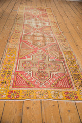 Distressed Oushak rug showing blush, ivory, oxidized silver geometric patterns and saffron border.