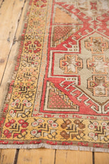 Saffron yellow border with blush and grey geometric patterns on a distressed Oushak runner.