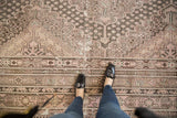Distressed vintage Khotan rug featuring scalloped medallions, germinating seeds, and soft patina.