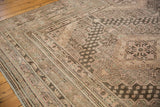 Scalloped contour and germinating seed patterns on a distressed vintage Khotan carpet.